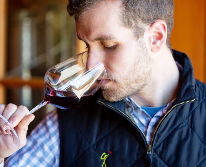 Photo of a man sipping wine at Grace Winery