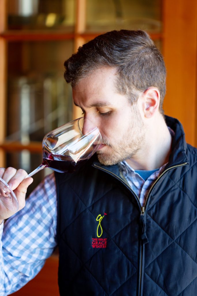 Photo of a man sipping wine at Grace Winery